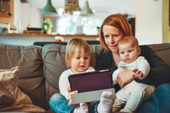 Mother with two children looking at iPad